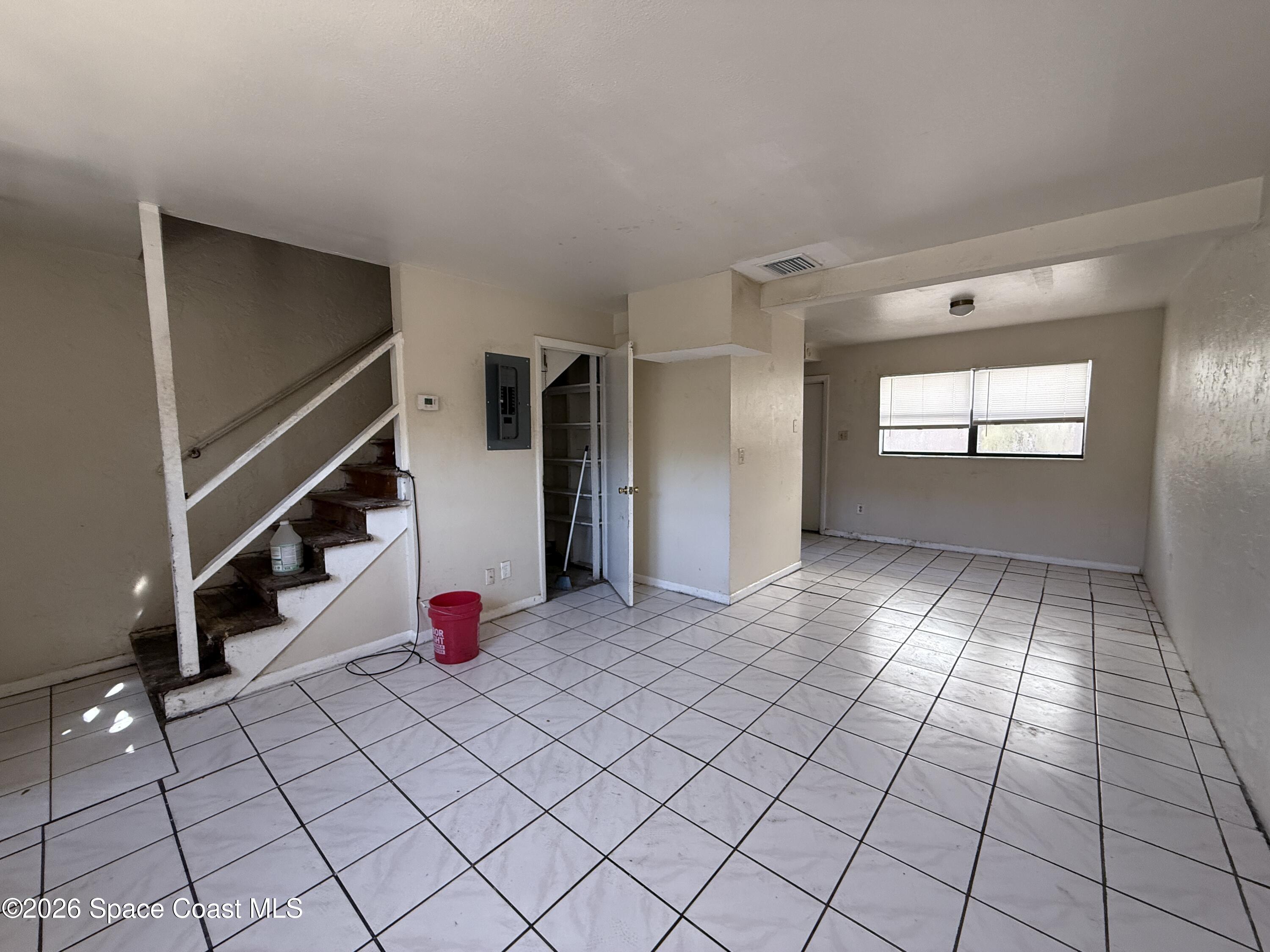 27 Ella Street, Unit B Melbourne, FL 32935 - Photo 8 of 18 a view of an empty room and stairs