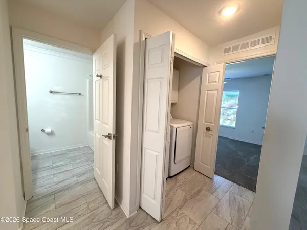 a view of a hallway with wooden shelves