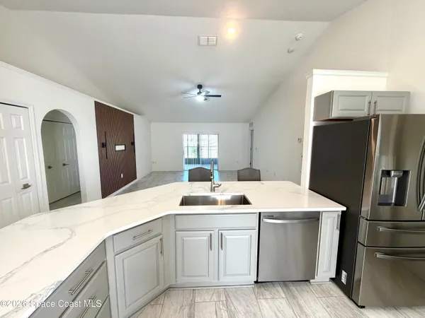 a kitchen with a refrigerator sink and stove