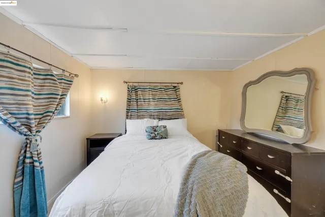 a bedroom with a bed and a mirror