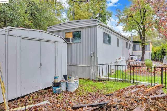 a white house that has tree in front of it