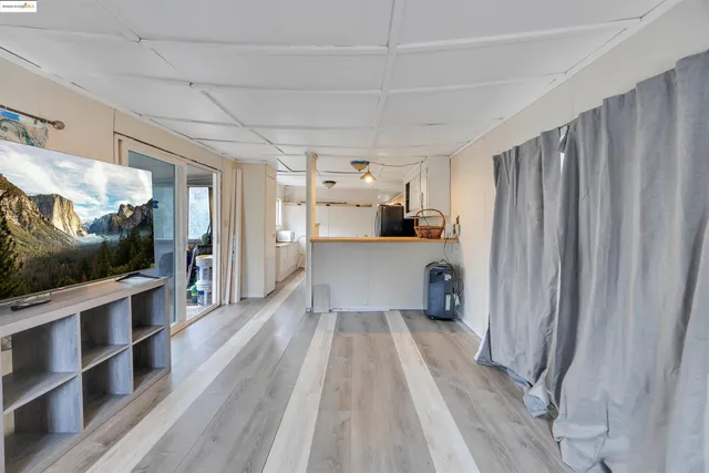 a kitchen with stainless steel appliances a refrigerator and wooden floor