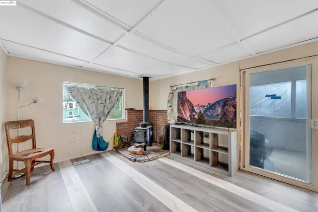a living room with furniture a window and a flat screen tv