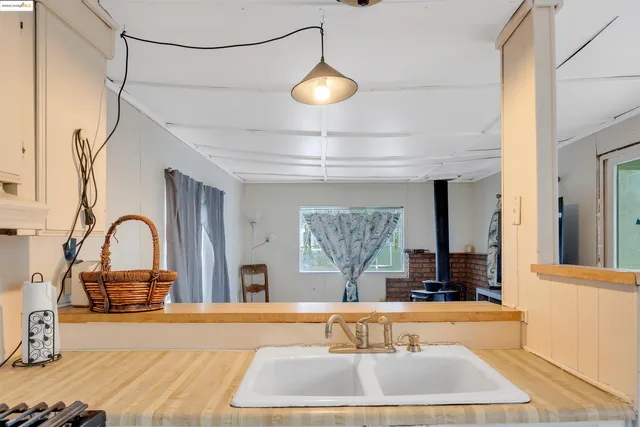 a kitchen with granite countertop a stove and a sink