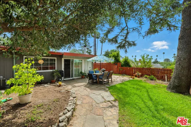 a view of a house with garden and sitting area