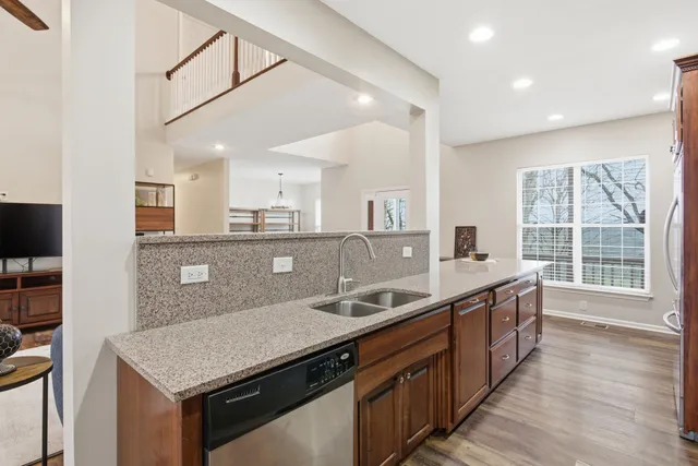 a kitchen with stainless steel appliances granite countertop a sink and a stove