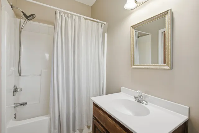 a bathroom with a sink a mirror and a shower