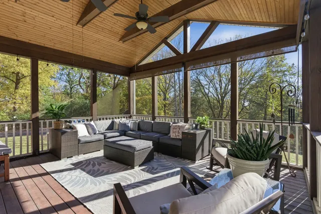 a living room with furniture and a floor to ceiling window