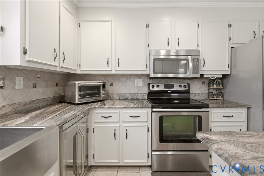 107 Oxford Road Hopewell, VA 23860 - Photo 18 of 50 White cabinetry with dark hardware, stainless stee