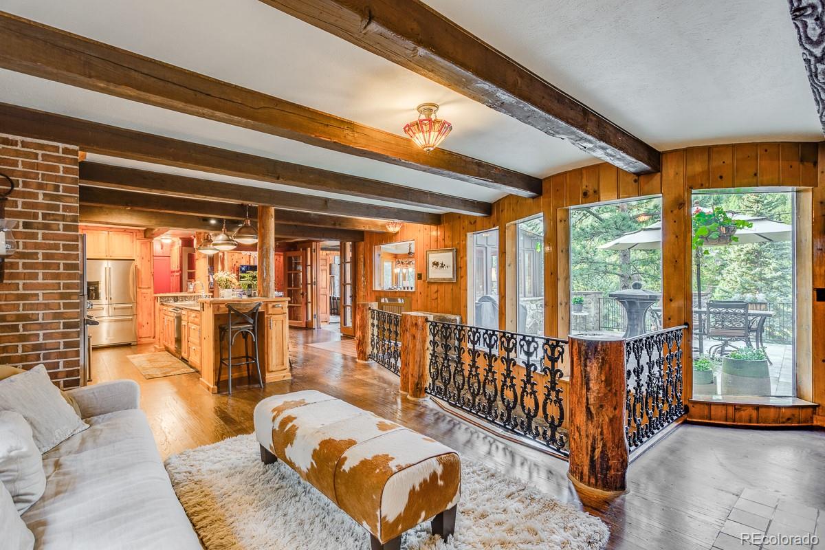 30403 Upper Bear Creek Road Evergreen, CO 80439 - Photo 12 of 40 a living room with furniture and a large window