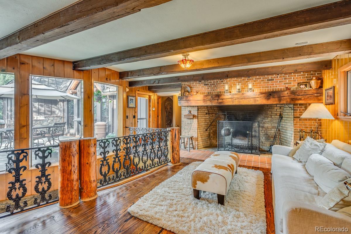 30403 Upper Bear Creek Road Evergreen, CO 80439 - Photo 13 of 40 a bedroom with furniture and a fireplace