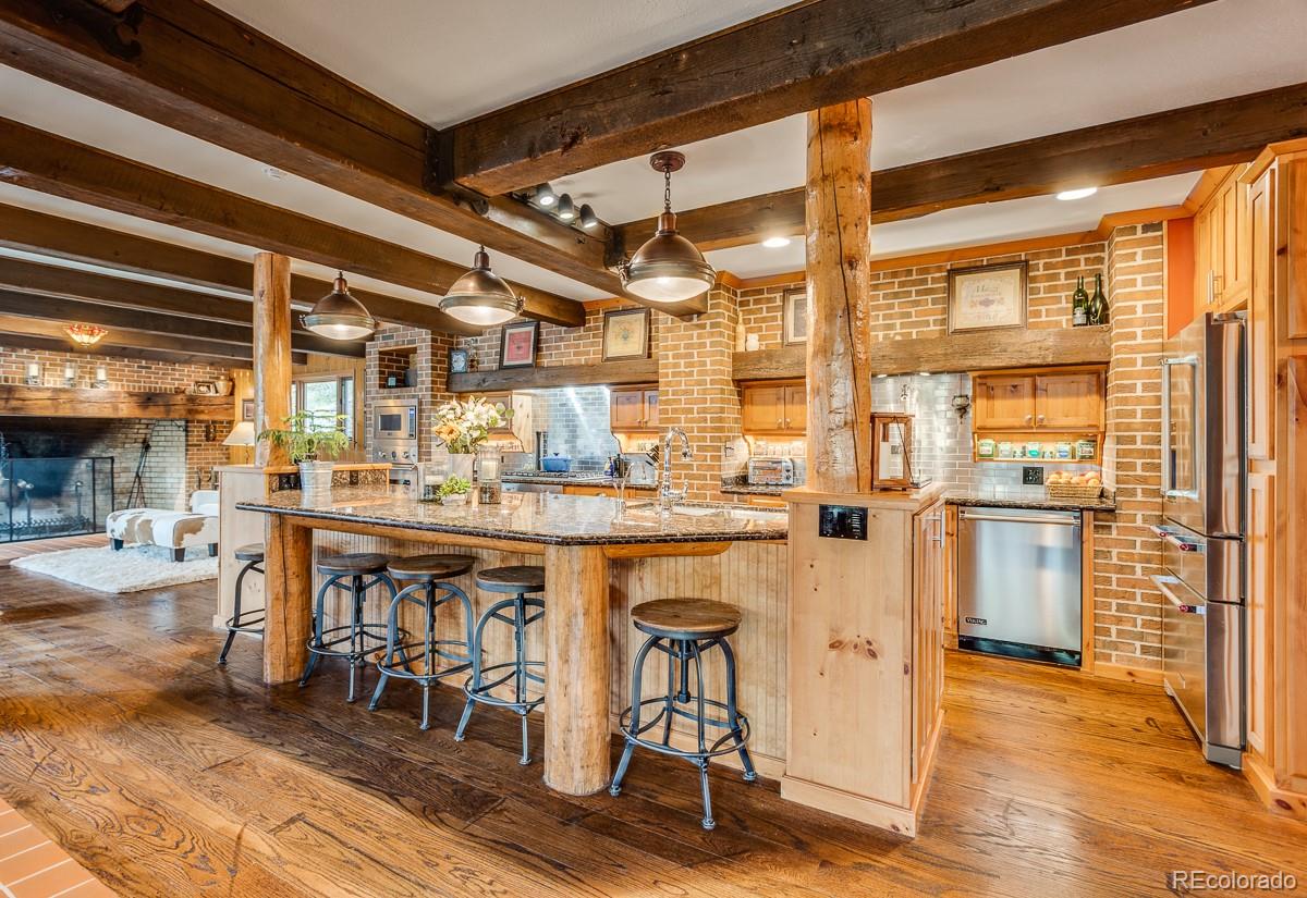 30403 Upper Bear Creek Road Evergreen, CO 80439 - Photo 14 of 40 a dining table with chairs and window