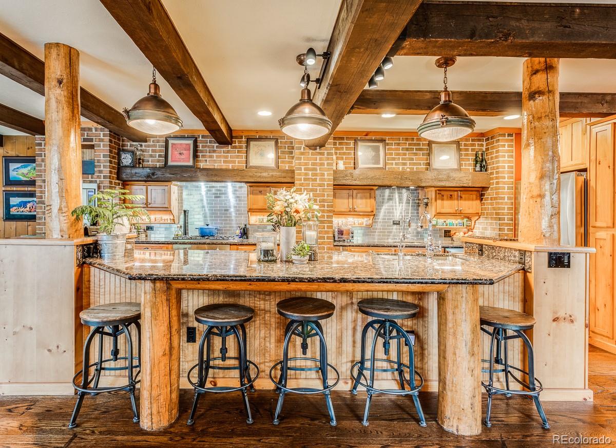 30403 Upper Bear Creek Road Evergreen, CO 80439 - Photo 17 of 40 a dining table with chairs and window