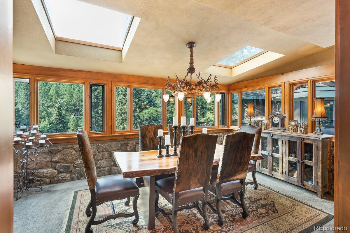 30403 Upper Bear Creek Road Evergreen, CO 80439 - Photo 18 of 40 a view of a dining room with furniture window and outside view