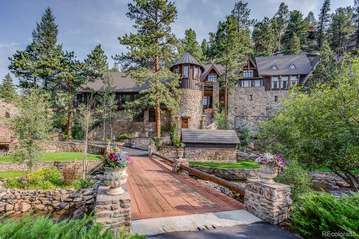 30403 Upper Bear Creek Road Evergreen, CO 80439 - Photo 2 of 40 a front view of a house with garden