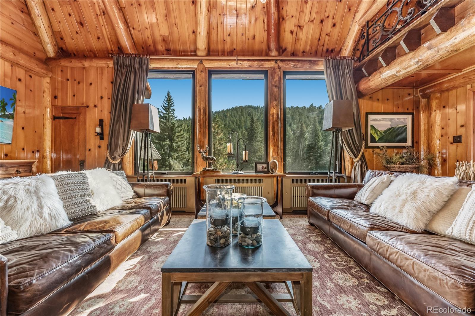 30403 Upper Bear Creek Road Evergreen, CO 80439 - Photo 22 of 40 a living room with furniture fireplace and a large window