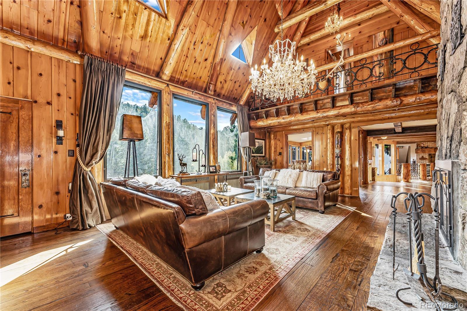 30403 Upper Bear Creek Road Evergreen, CO 80439 - Photo 23 of 40 a living room with furniture and a fireplace