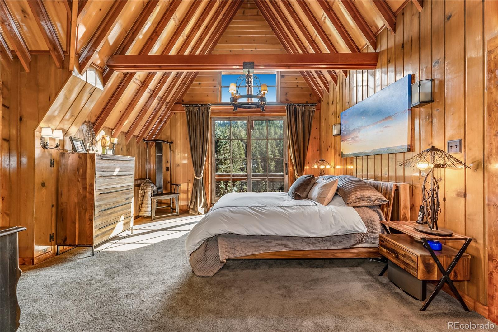 30403 Upper Bear Creek Road Evergreen, CO 80439 - Photo 24 of 40 a bed sitting in a room next to a window