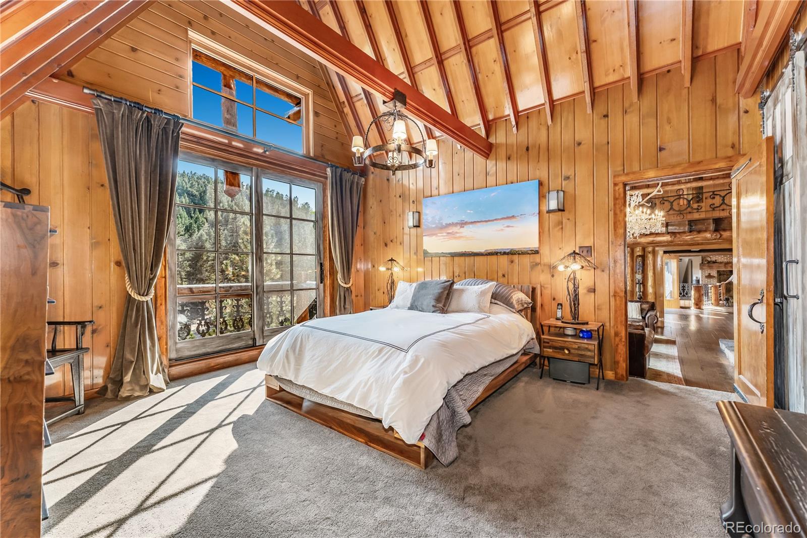 30403 Upper Bear Creek Road Evergreen, CO 80439 - Photo 25 of 40 a bedroom with a bed and a large window