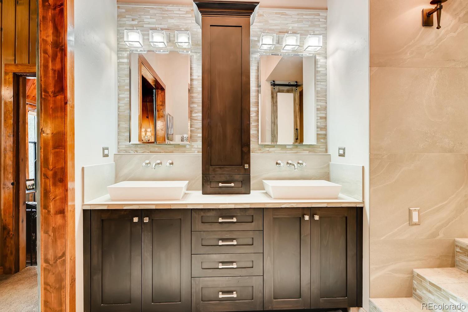 30403 Upper Bear Creek Road Evergreen, CO 80439 - Photo 26 of 40 a bathroom with a sink and a mirror