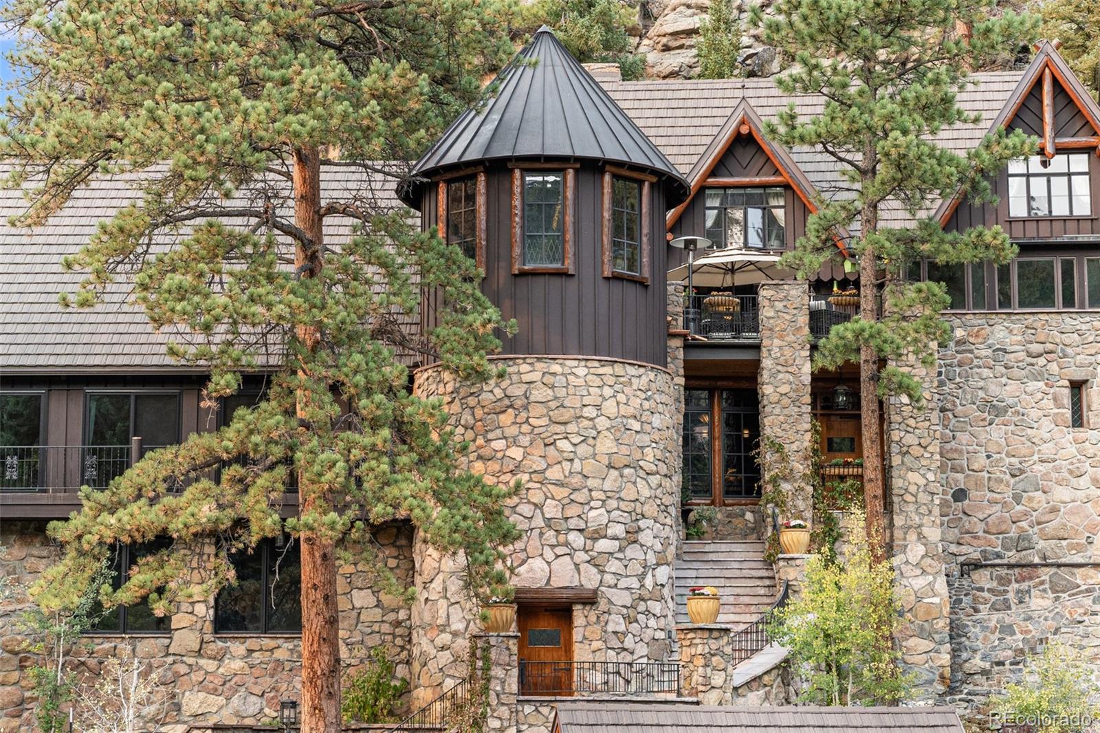 30403 Upper Bear Creek Road Evergreen, CO 80439 - Photo 3 of 40 front view of a house with a small yard