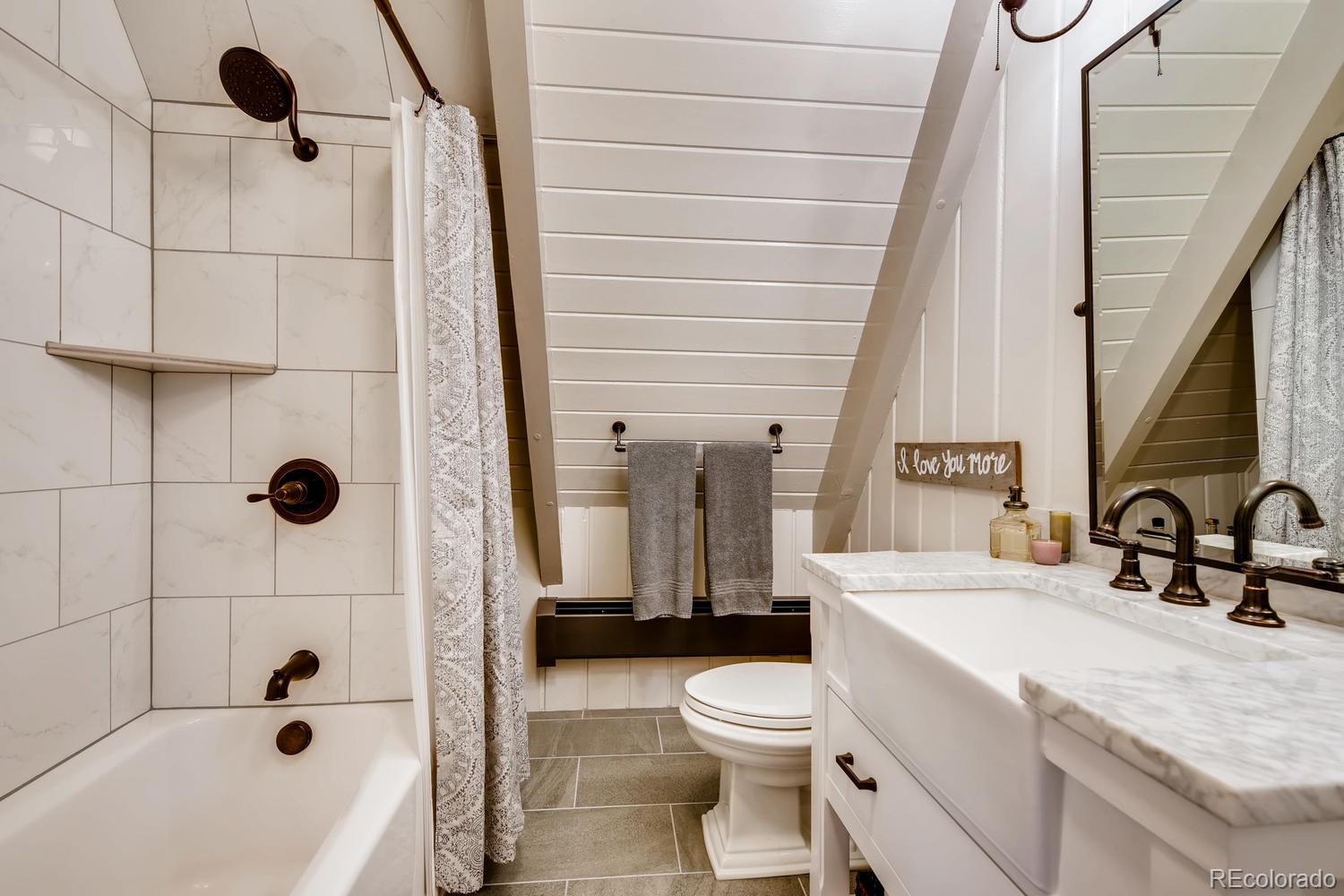 30403 Upper Bear Creek Road Evergreen, CO 80439 - Photo 36 of 40 a bathroom with a sink a toilet and shower