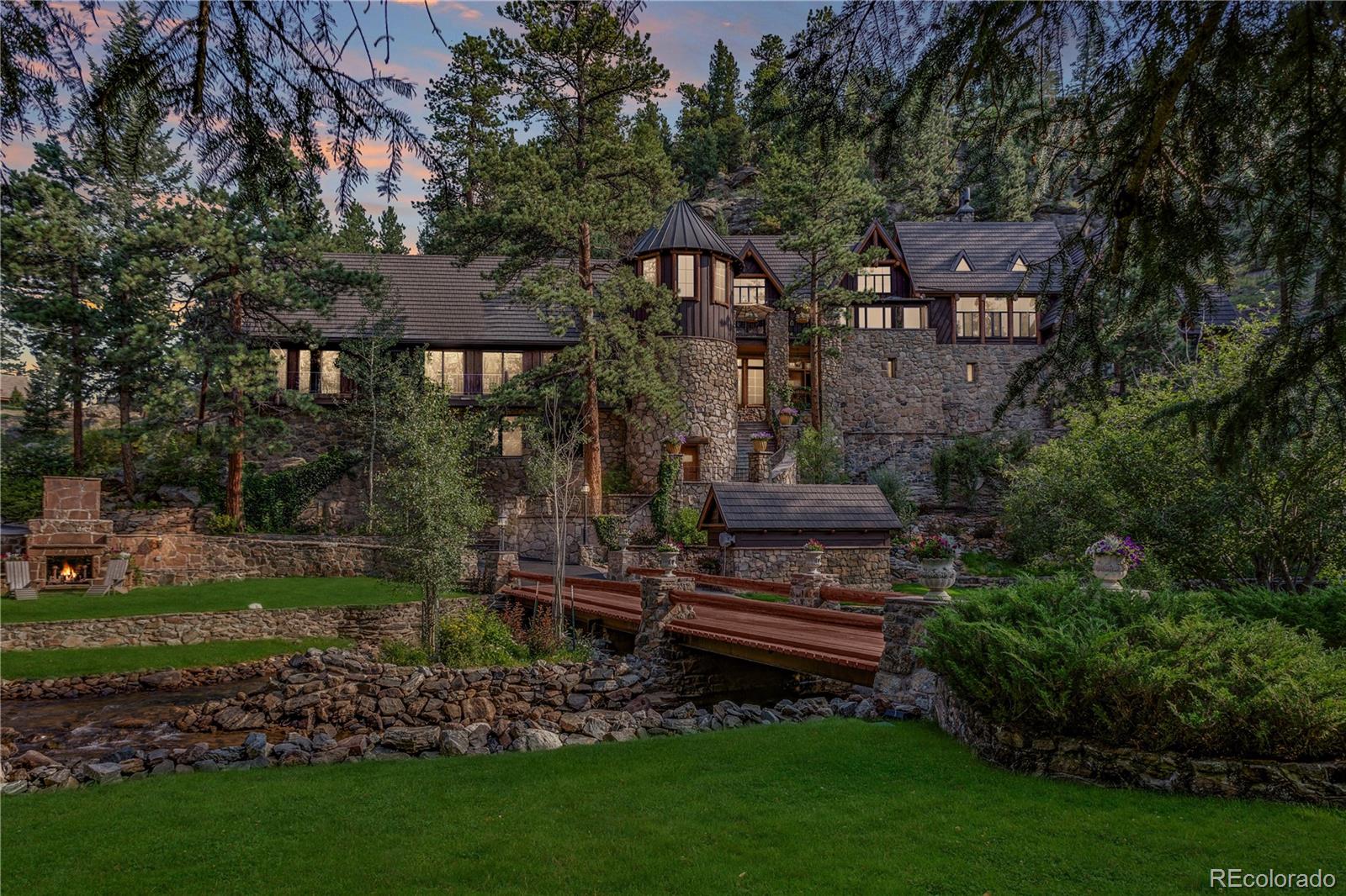 30403 Upper Bear Creek Road Evergreen, CO 80439 - Photo 39 of 40 a front view of a house with garden