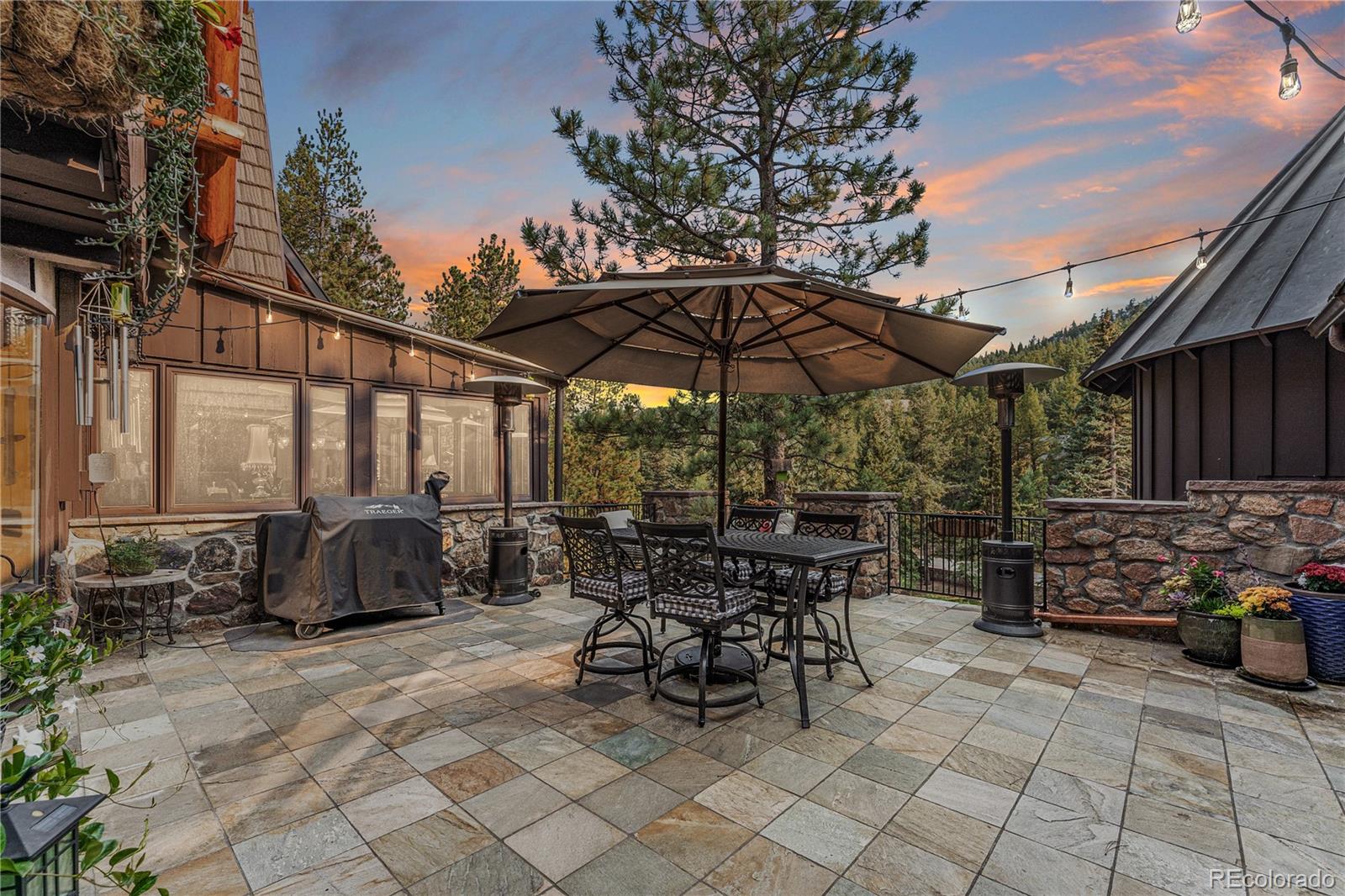 30403 Upper Bear Creek Road Evergreen, CO 80439 - Photo 40 of 40 a patio with a patio table and chairs
