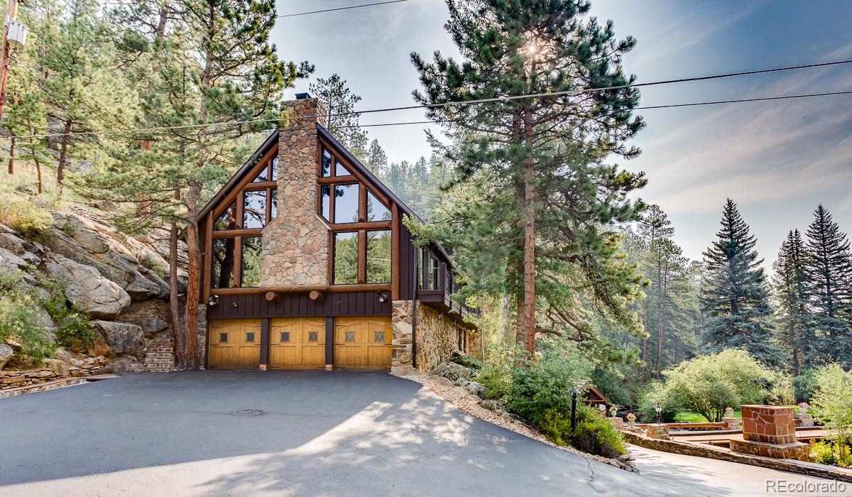 30403 Upper Bear Creek Road Evergreen, CO 80439 - Photo 4 of 40 a view of house with outdoor space and trees around