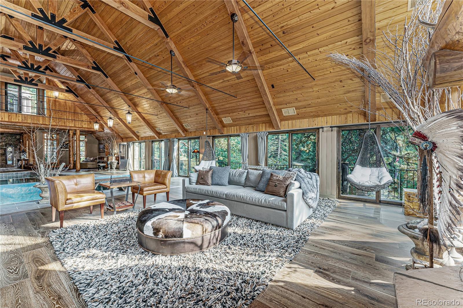 30403 Upper Bear Creek Road Evergreen, CO 80439 - Photo 8 of 40 a outdoor living space with patio furniture and a potted plant