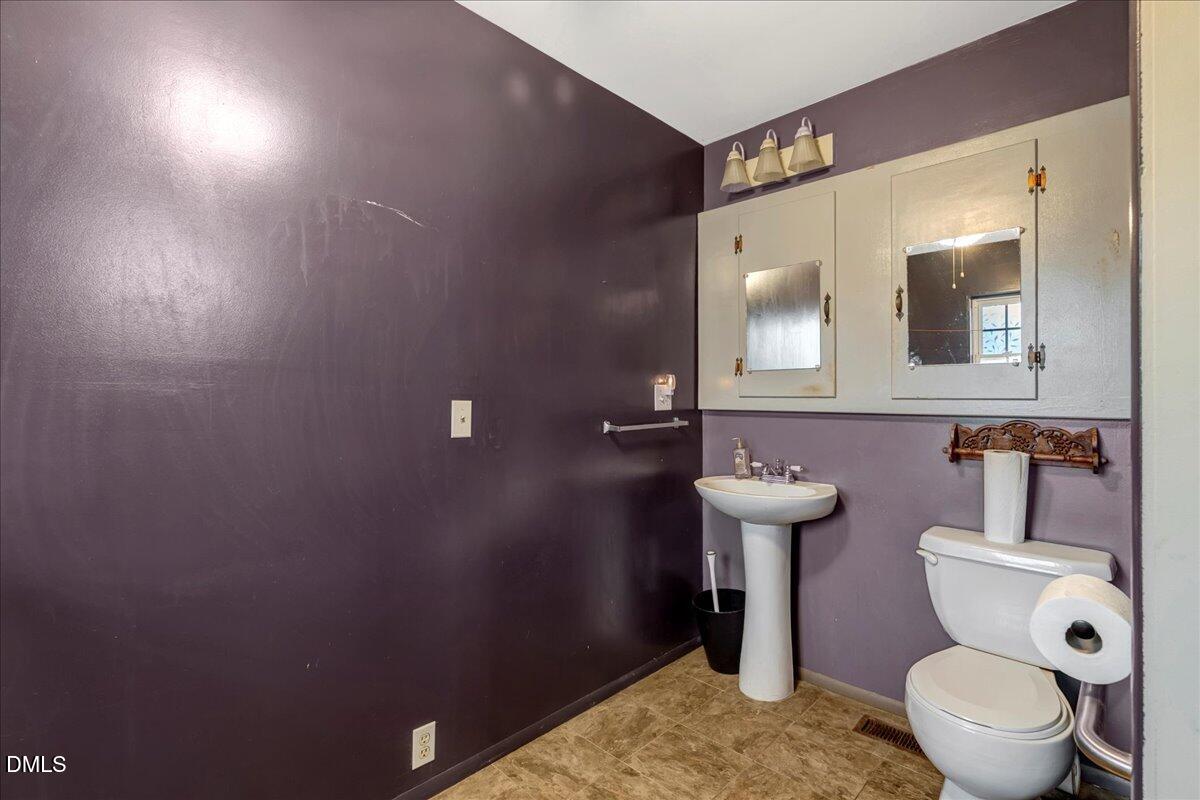 4049 Highway 58 Buffalo Junction, VA 24529 - Photo 12 of 21 a bathroom with a toilet sink and mirror