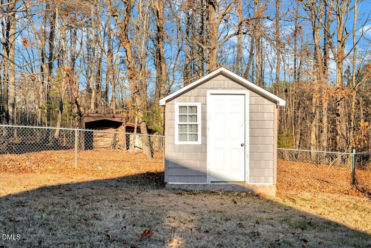 4049 Highway 58 Buffalo Junction, VA 24529 - Photo 17 of 21 a backyard of a house with wooden fence and large trees