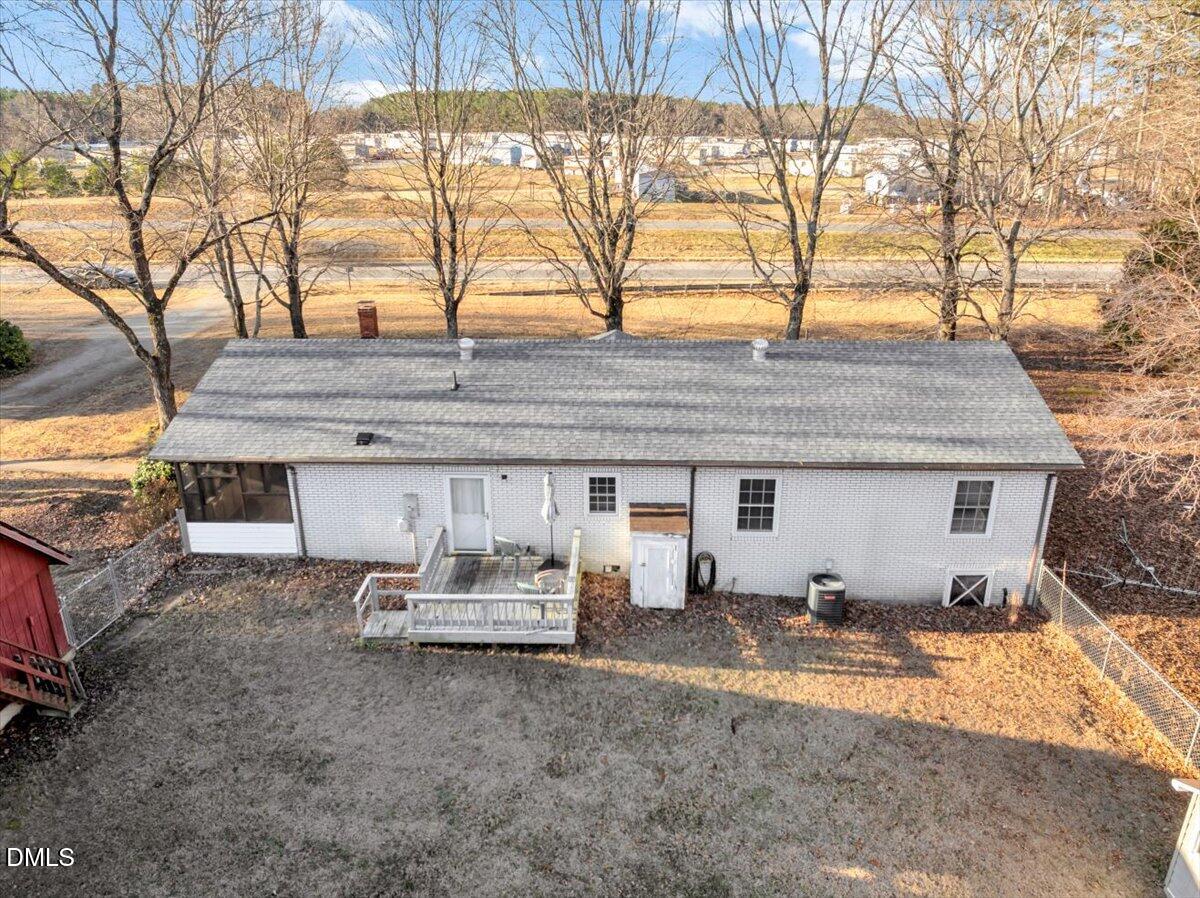 4049 Highway 58 Buffalo Junction, VA 24529 - Photo 4 of 21 a backyard of a house with table and chairs under an umbrella