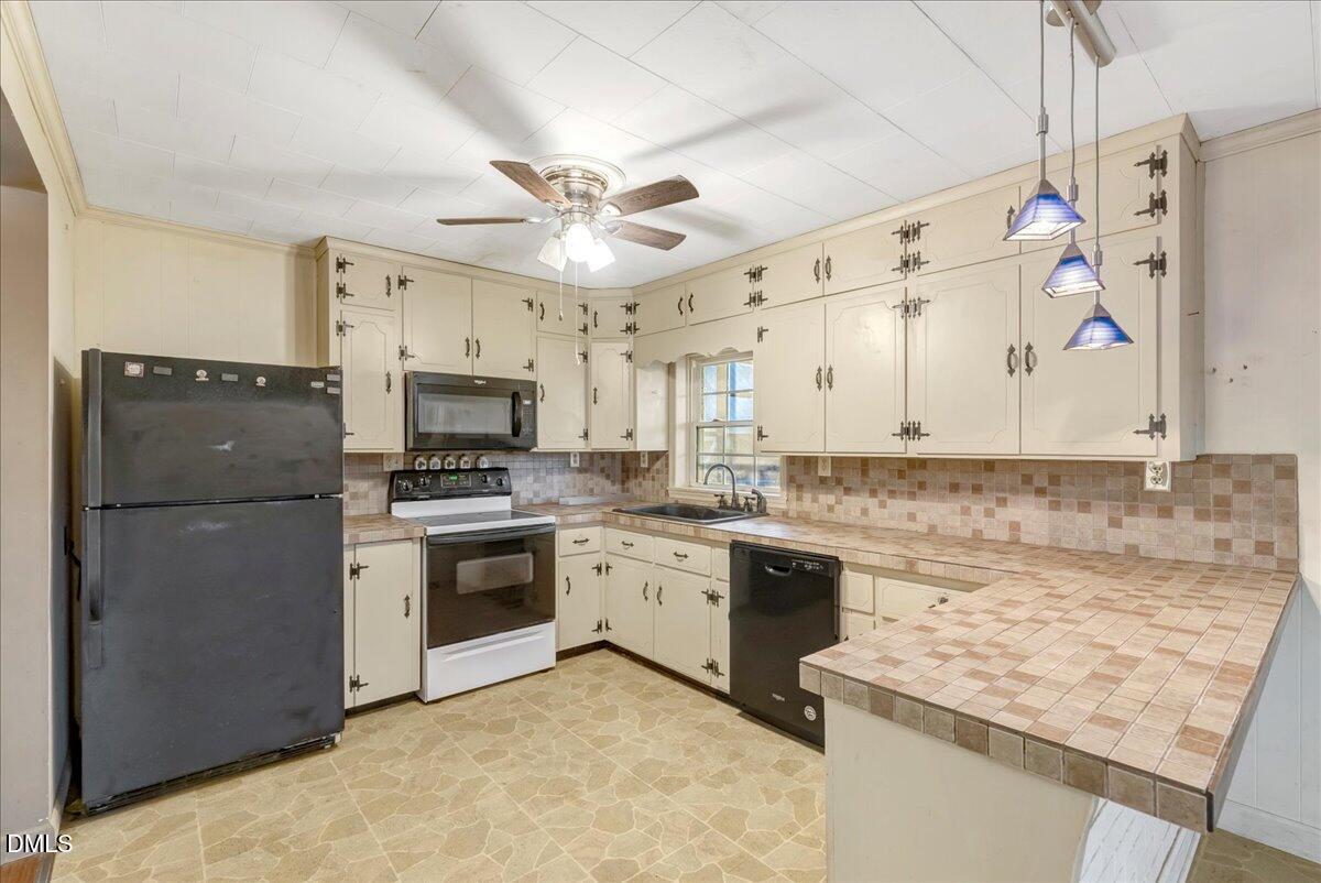 4049 Highway 58 Buffalo Junction, VA 24529 - Photo 6 of 21 a kitchen with granite countertop a sink stainless steel appliances and cabinets