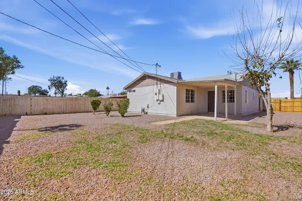 a view of a house with backyard and tree