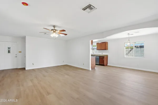 wooden floor in an empty room with a window