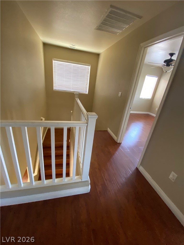 489 Foster Springs Road Las Vegas, NV 89148 - Photo 10 of 30 Rich hardwood flooring leads to a bright landing with a stairwell and additional rooms.
