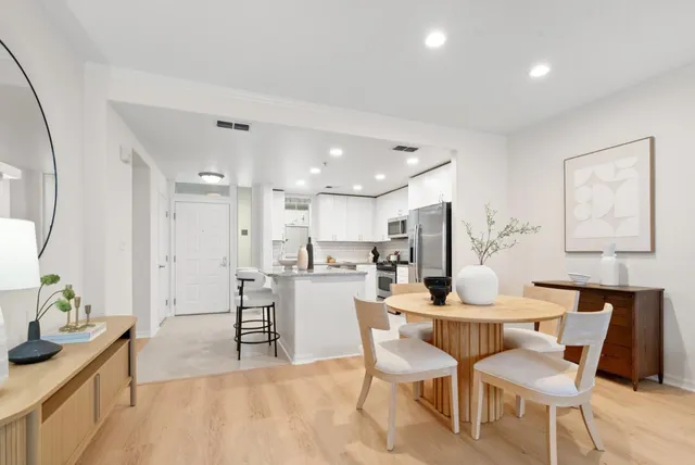 a dining room with furniture and wooden floor