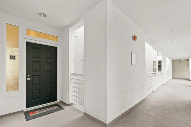 a living room with fireplace furniture and a large window