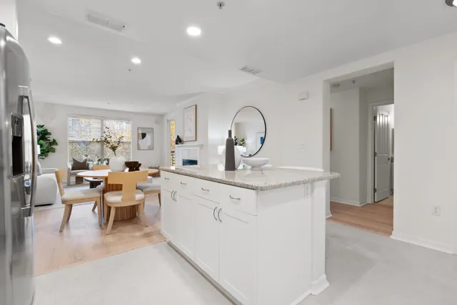 a bathroom with a granite countertop sink toilet a large mirror a bathtub and shower