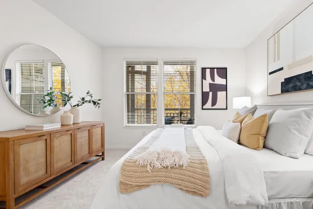 a bedroom with a bed and a night stand