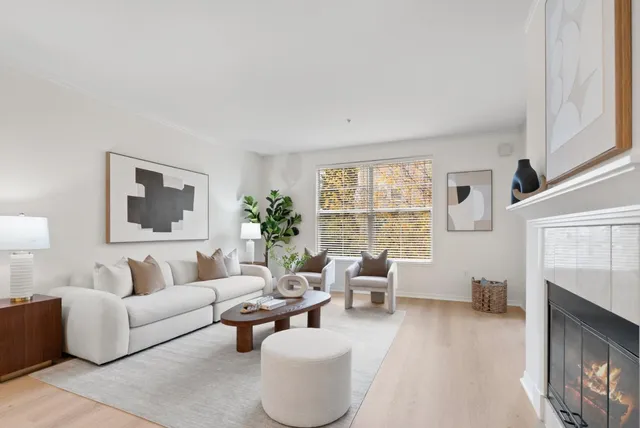 a living room with furniture a window and a fireplace