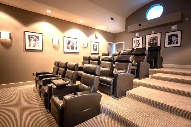 a living room with lots of furniture and a large window