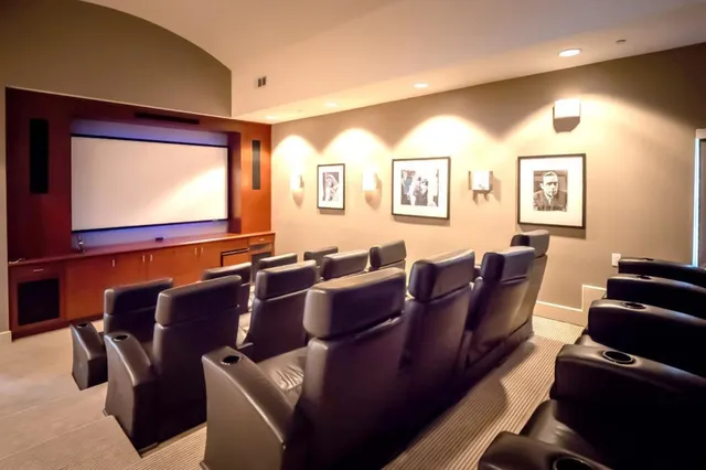 a living room with furniture large window and a fireplace