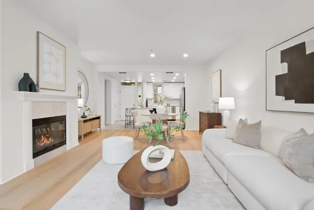 a living room with furniture a fireplace and a table