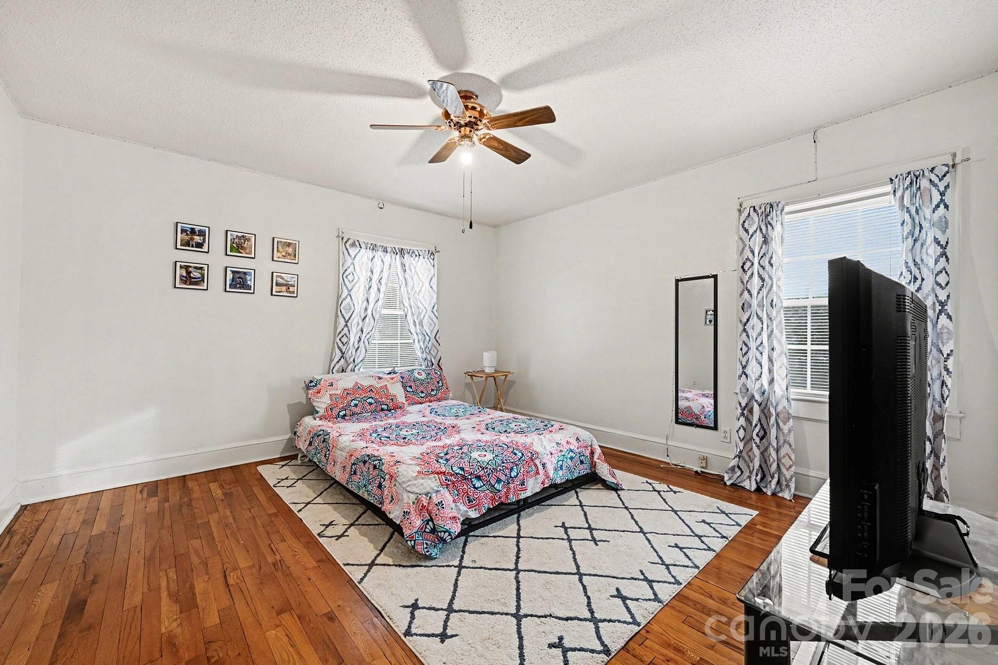 409 Miles Road Shelby, NC 28150 - Photo 13 of 23 a bedroom with a bed and a flat tv screen