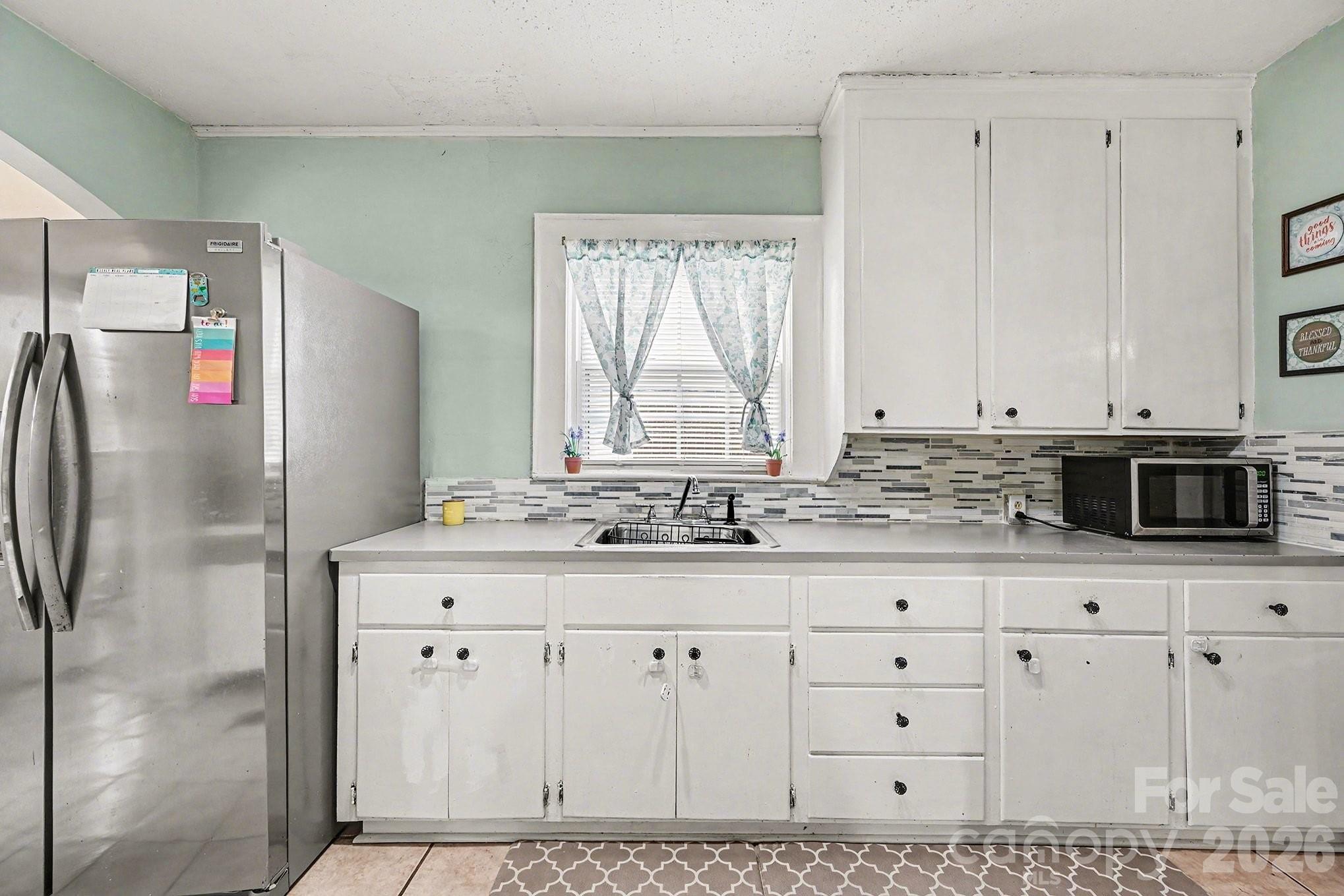 409 Miles Road Shelby, NC 28150 - Photo 4 of 23 a kitchen with granite countertop white cabinets and refrigerator