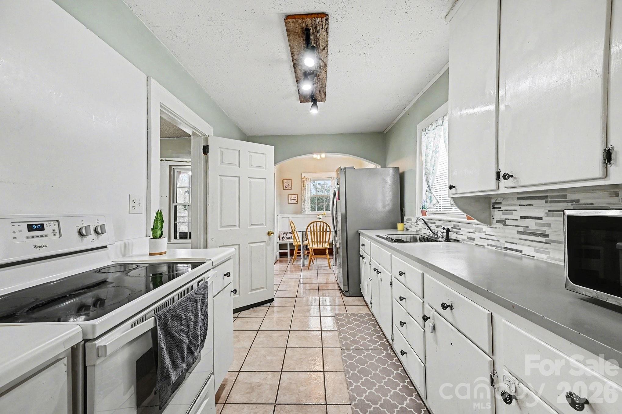409 Miles Road Shelby, NC 28150 - Photo 6 of 23 a kitchen with stainless steel appliances granite countertop a sink stove and cabinets
