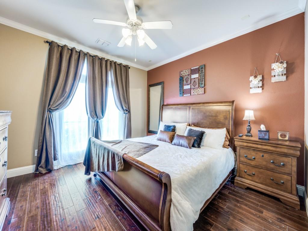 5721 Lunsford Road Plano, TX 75024 - Photo 11 of 17 a bedroom with a bed and a chandelier
