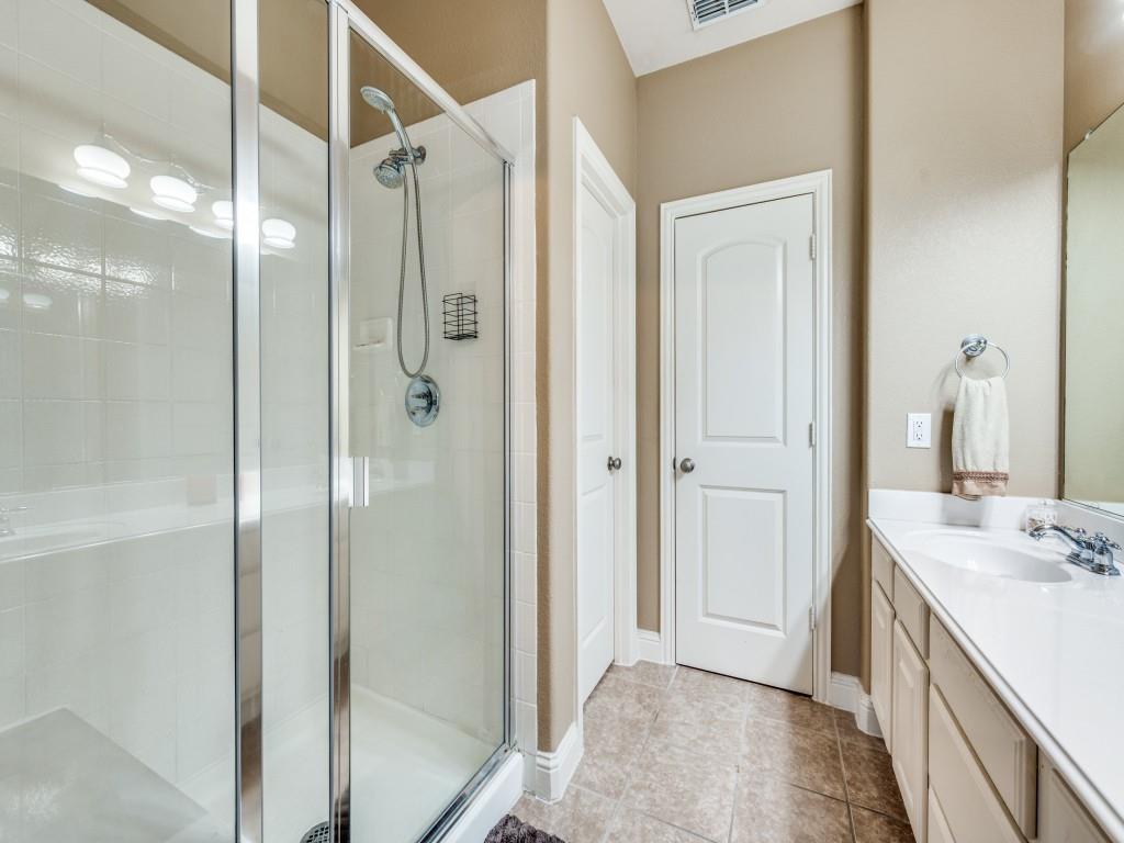 5721 Lunsford Road Plano, TX 75024 - Photo 13 of 17 a bathroom with a shower sink and mirror